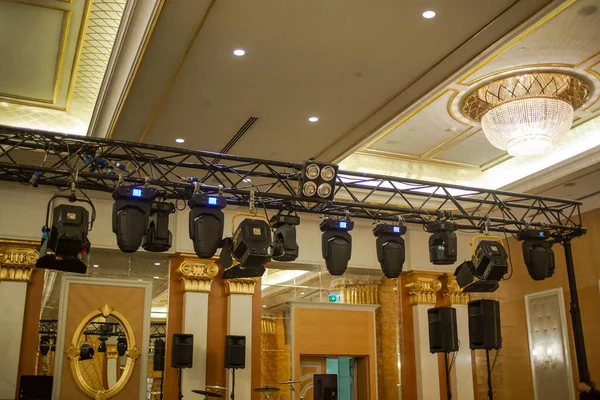 Professional stage light fixtures hanged on truss. Party show stage set up, rehearsal, sound and light check.