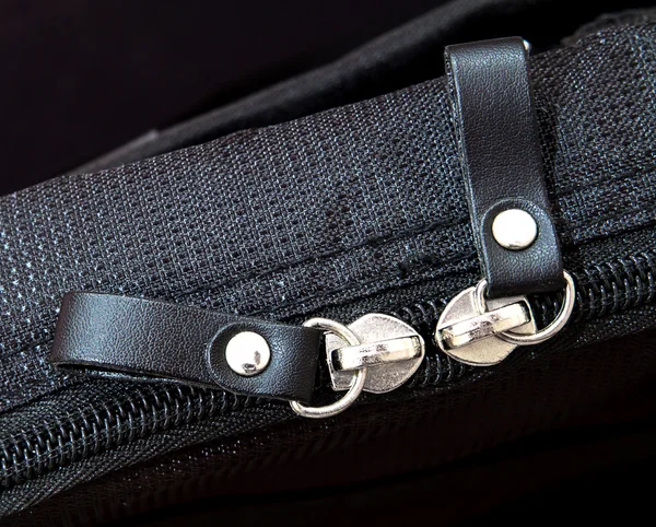 Metal zipper on black synthetic fabric