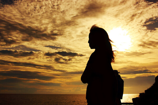 silhouette of woman standing to thinking of some things with hope