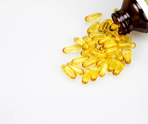 Closeup yellow soft gelatin supplement fish oil capsule — Stock Photo, Image