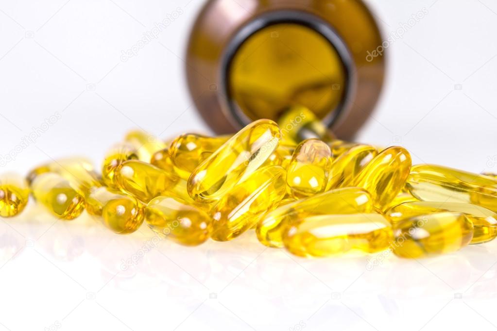 Closeup yellow soft gelatin supplement fish oil capsule — Stock Photo