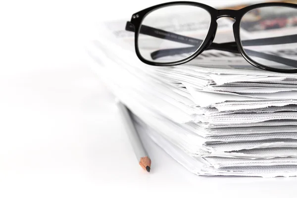 Reading eyeglasses with stacking of newspaper background , busin — Stock Photo, Image