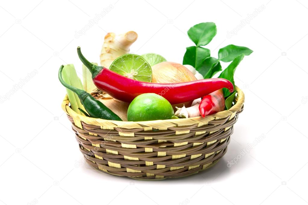 selective focus herb and spice ingredients in wooden basket on w