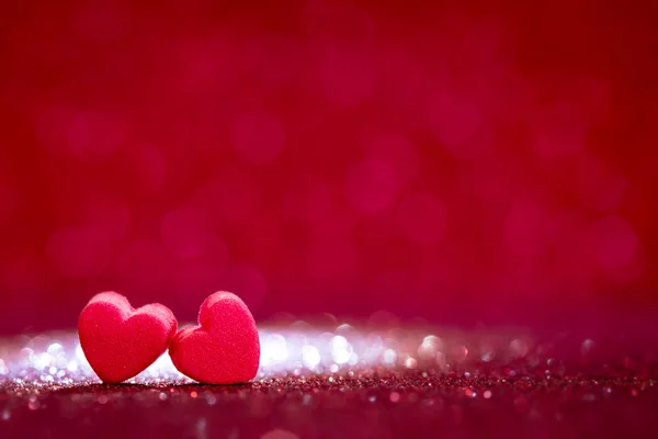 Red Heart shapes on abstract light glitter for valentines day — Stock Photo, Image