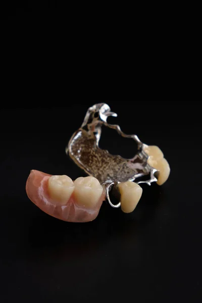 Dental appliances and dentures, on a black background.