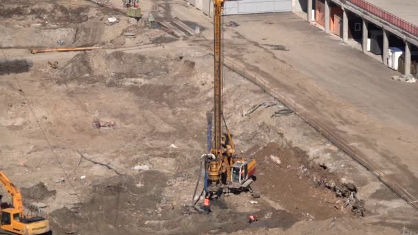 Drilling machine operation at the construction site of the house — Stock Footage Drilling Machine Operation Construction Site House Royalty Free Stock Video
