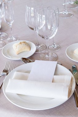 Çanak çömlek, çatal bıçak ve şarap kadehleriyle dolu güzel bir düğün masasının ayrıntıları.