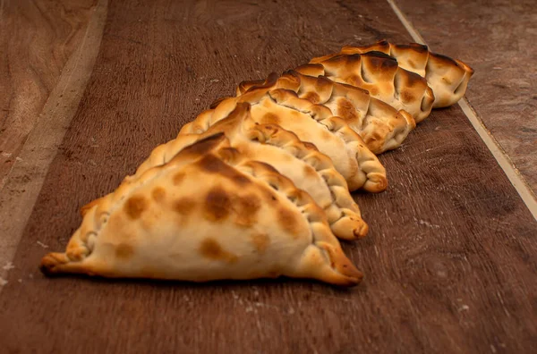 Παραδοσιακά Αργεντινής empanadas πίτα στο τραπέζι, κρέας Κοτόπουλο και λαχανικά — Φωτογραφία Αρχείου