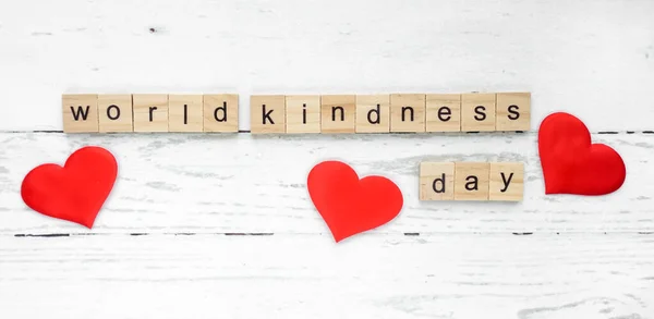 worlh kindness day. words from wooden cubes with letters. good heart