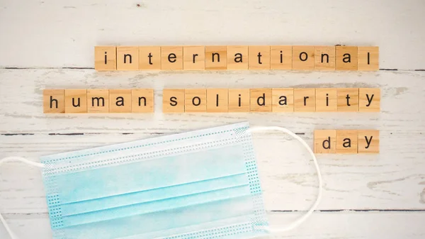 international human solidarity day.words from wooden cubes with letters photo