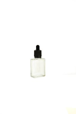 A bottle with a pipette, isolated on a white background. glass container for cosmetic skin care products. Aromatherapy, essence, or perfume is empty. a bottle of cosmetic dropper. Amber apothecary flask with pipette. Beauty collagen pipette vial, nat