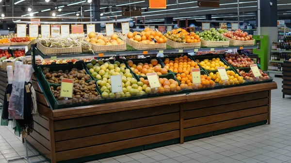 Shelf with fresh citrus fruits in supermarket Stock Photo