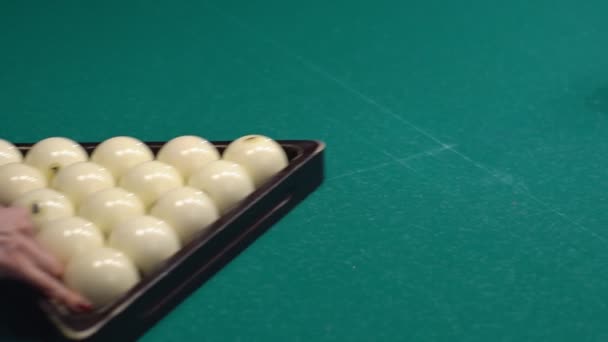 A woman getting ready to start a game of billiards. Triangle of billiard balls. — Stock Video
