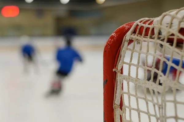 Children playing ice hockey in arena. Young hockey players practising. Royalty Free Stock Photos