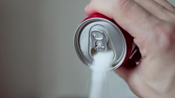 Man hand holding soda drink can pouring sugar stream - unhealthy drink concept — Stock Video