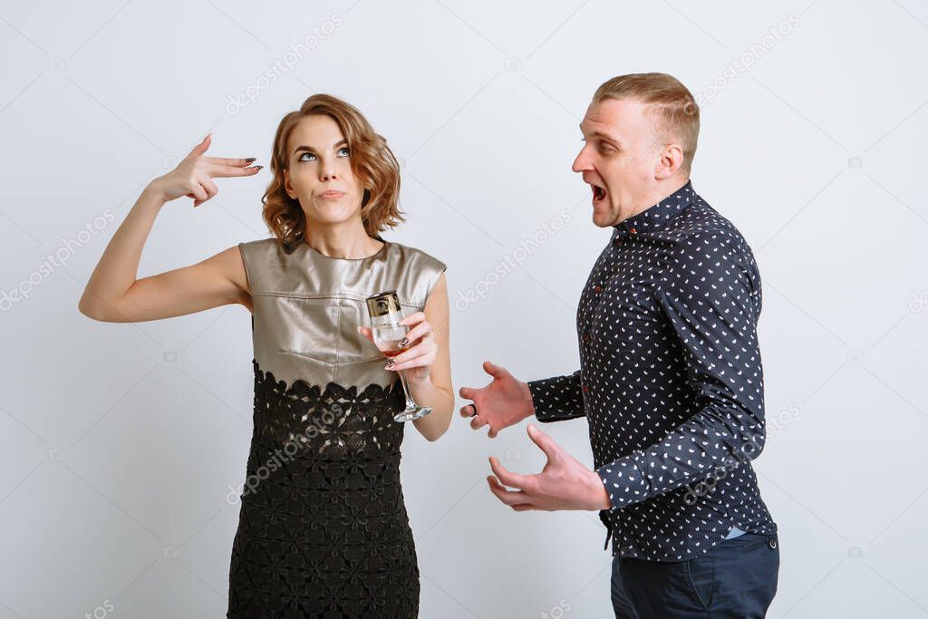 The girl makes a gesture as if shooting herself with a gun, against the background of a guy yelling at her.