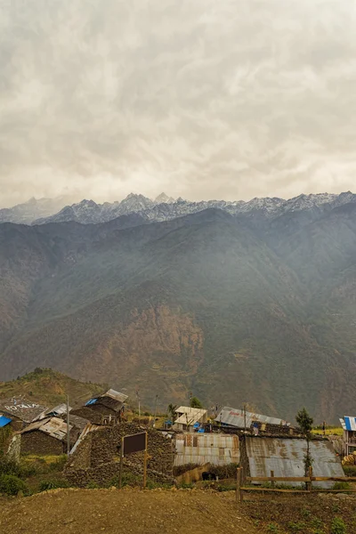 Village with mountain range at background — Stock Photo, Image