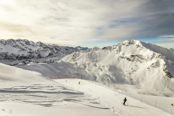 Skiing among french Alps and EURO-shaped rock on background — Stock Photo, Image