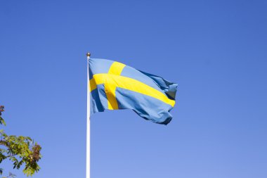 Sweden flag in front of a blue sky clipart