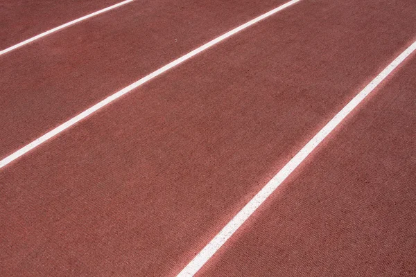 Las pistas en el estadio con recubrimiento artificial de caucho — Foto de Stock