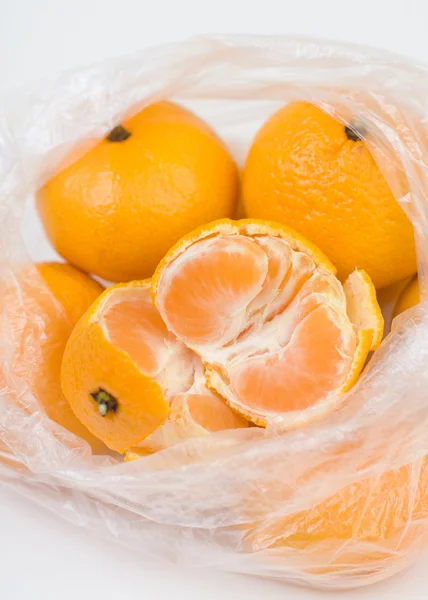 Mandariner i polyethylenposen - Stock-foto