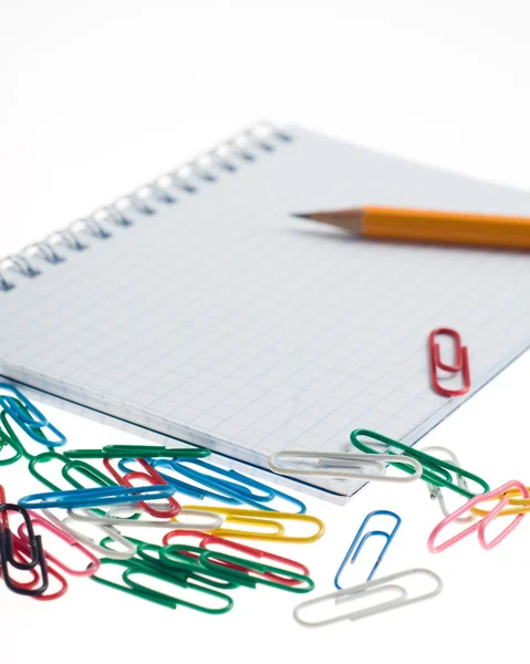 Pencil on the notepad with clips composition — Stock Photo, Image