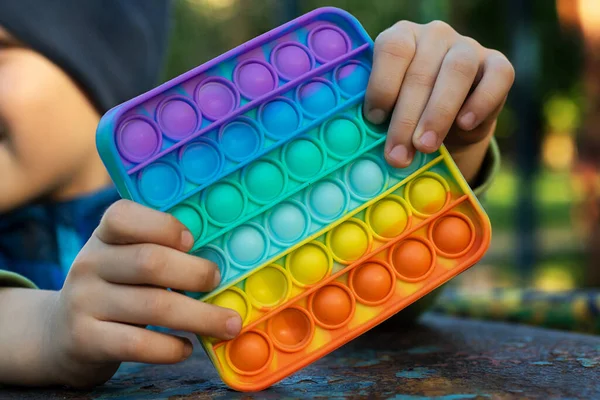 Anonymous Child Hold His Hands Sensory Toy Pop Shows Front — Stock Photo, Image