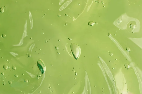 Suero Ondulado Con Gelatina Con Burbujas Fondo Verde Frotis Cosmética — Foto de Stock