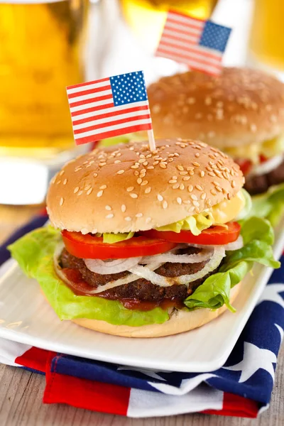 Hamburgers and beer. — Stock Photo, Image