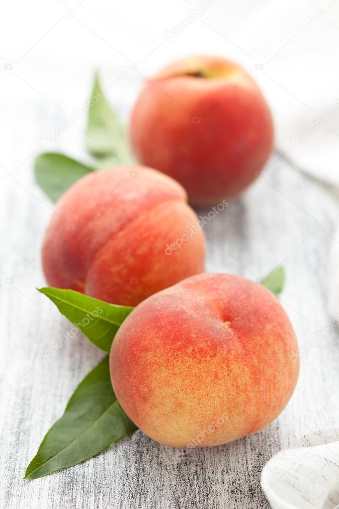 Peaches on rustic table.