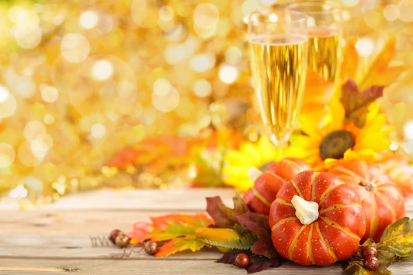 Autumn arrangement with wine, sunflowers and pumpkins. — Stock Photo, Image