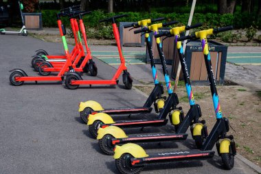 Bükreş, Romanya, 30 Nisan 2021: Şehir merkezinde vatandaşlar ve turistler için uygun olan özel mobil uygulama kullanılarak kiralık elektrikli scooter 'ların suya düşmesi