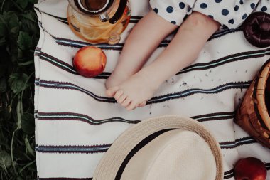 Baby feet. Beautiful trendy picnic. Romantic picnic. Provence atmosphere. Peaches and lavender.	