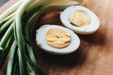 Boiled eggs with green onions. Ingredients for the spring salad. Healthy food.	