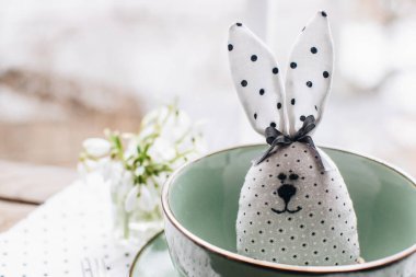 Tavşan yumurtalı Paskalya sofrası. Paskalya masa süslemeleri. Tatil için masa hazırlıyorum. Tavşan tabakta. Bahar çiçekleri. Zarif Paskalya dekoru. Çapraz çörek.