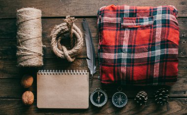 Hipster traveler hiking pack. Set for hiking in the mountains or forest. Scout concept. Rustic flat lay on a wooden table. Hipster lumberjack flat lay.	