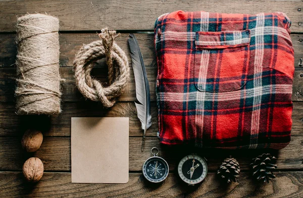 Hipster traveler hiking pack. Set for hiking in the mountains or forest. Scout concept. Rustic flat lay on a wooden table. Hipster lumberjack flat lay.	