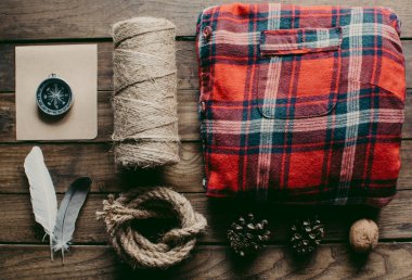 Hipster traveler hiking pack. Set for hiking in the mountains or forest. Scout concept. Rustic flat lay on a wooden table. Hipster lumberjack flat lay.	