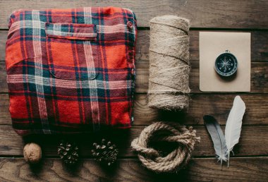 Hipster traveler hiking pack. Set for hiking in the mountains or forest. Scout concept. Rustic flat lay on a wooden table. Hipster lumberjack flat lay.	
