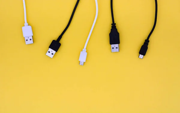 Top View Black White Usb Cables Yellow Background Copy Space Stockfoto