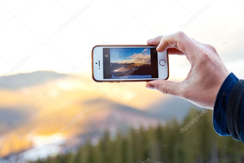 Camera mobile phone at beautiful sunrise