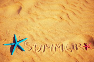 Summer background. Summer lettering on the sand
