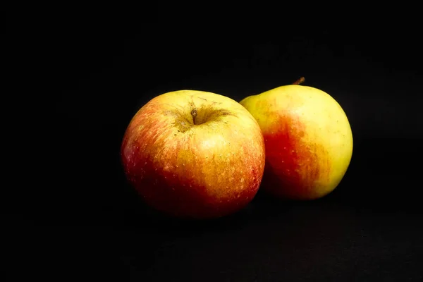 Fresh natural delicious apples on black background