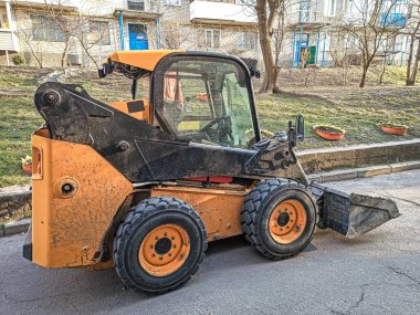 Şehrin sokaklarında yükleme ve boşaltma için küçük ön uç yükleyici.