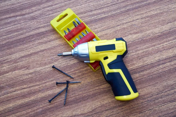 Cordless screwdriver with a set of nozzles, DIY repair. — Stock Photo, Image