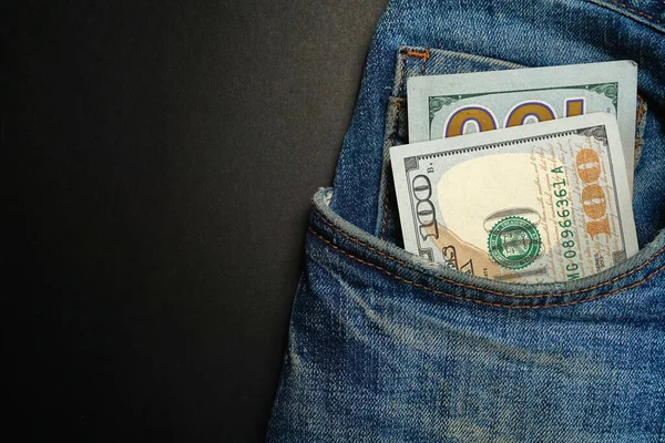 Kot pantolonun ön cebinde bir dolarlık banknot var. Cebinde para, nakit.