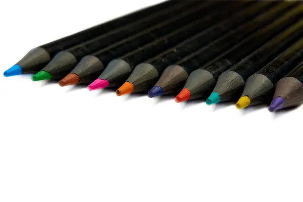 Colored pencils lying diagonally on white background. — Stock Photo, Image