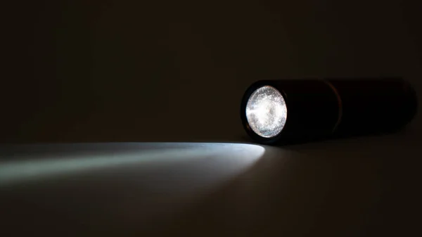 El feneri ve karanlıkta bir ışık huzmesi. Karanlıkta fener ışını. Karanlıkta fener ışığı