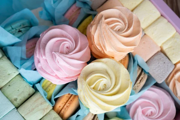 Berry colored marshmallow in a paper box, production of sweets, delivery of sweets. The perfect gift for a sweet tooth