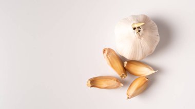 Beyaz arka planda izole edilmiş sarımsak manzarası. Ham sarımsak dilimi kopyalama alanı ile izole edilmiş. Beyaz sarımsak kafa.